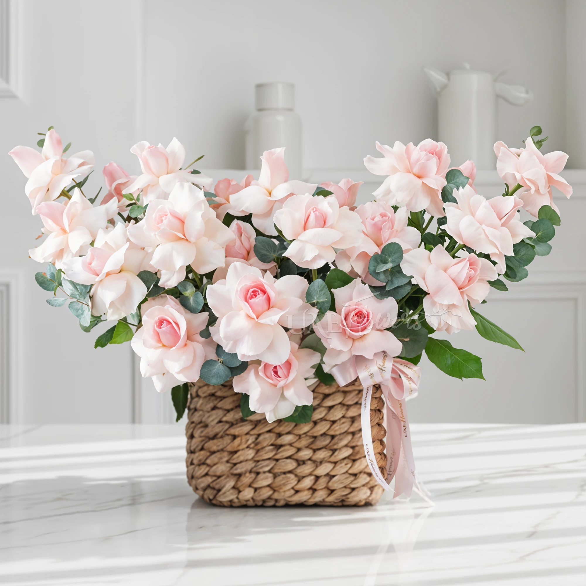 basket of blooming pink roses with lush green fillers