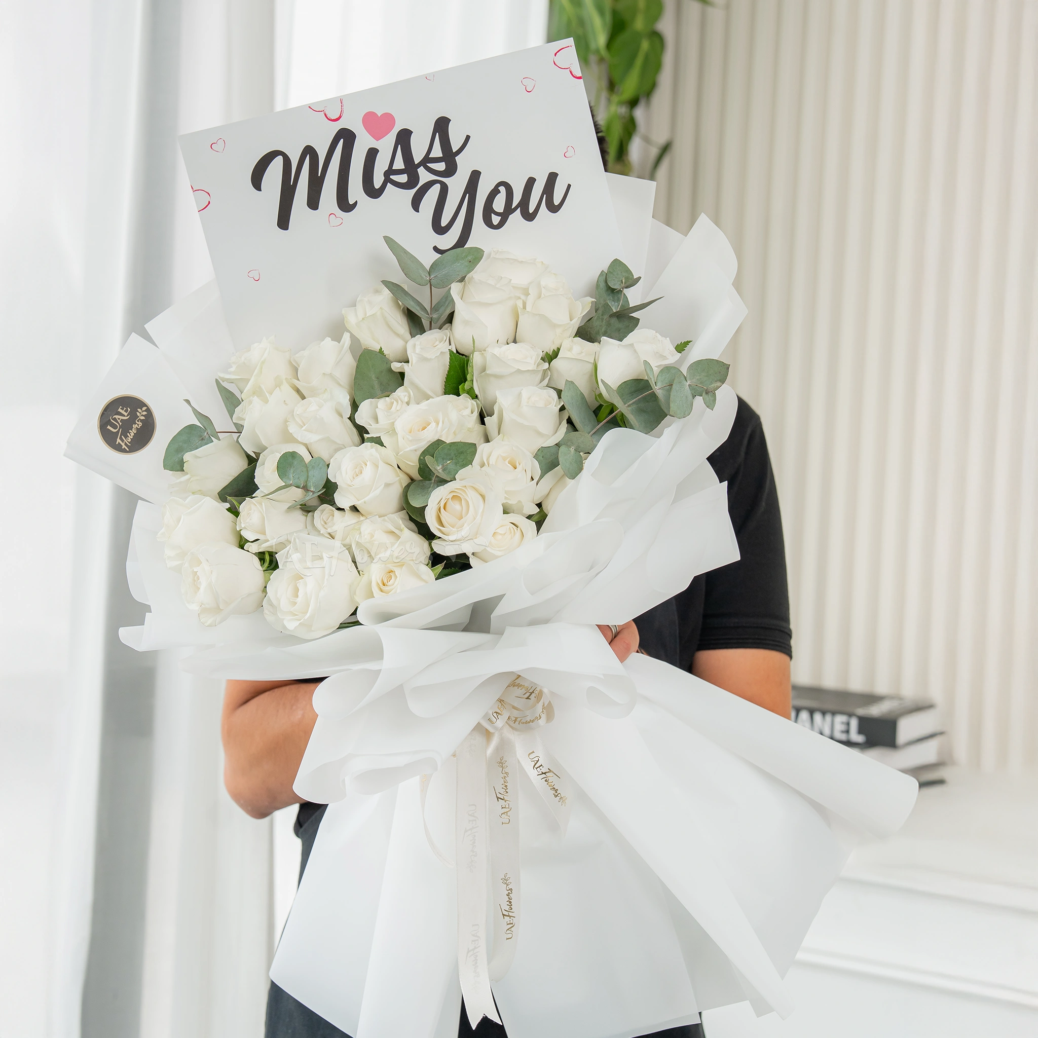 Bouquet of 25 white roses with greens in nice wrapping