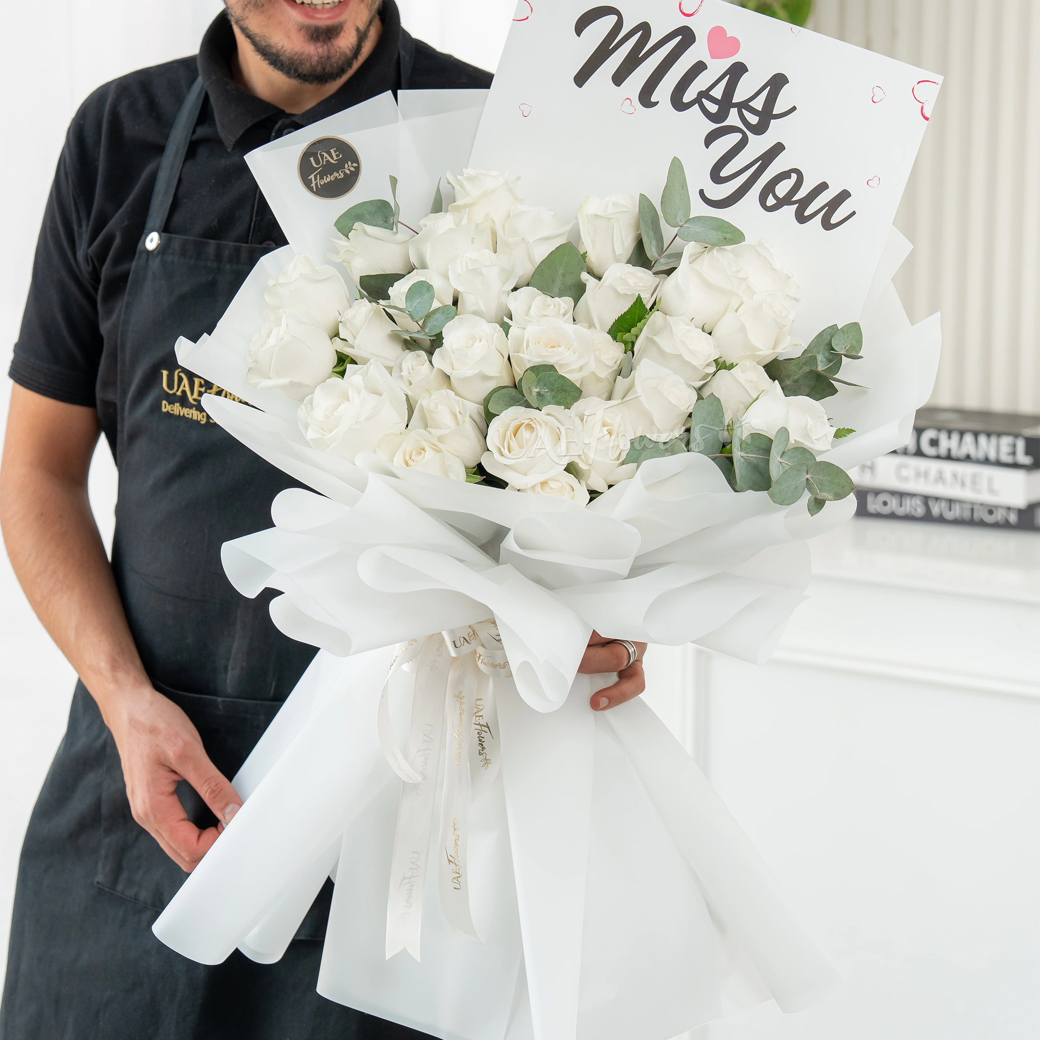 Bouquet of 25 white roses with greens in nice wrapping