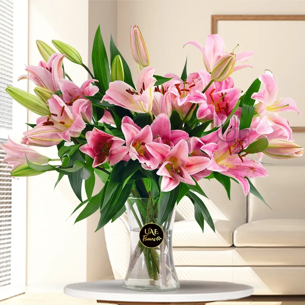 10 pink lilies with greens & fillers in a glass vase