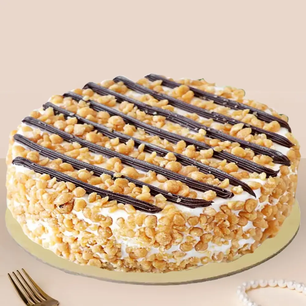 1 kg butterscotch cake topped with caramel crunch and chocolate drizzle on a golden base