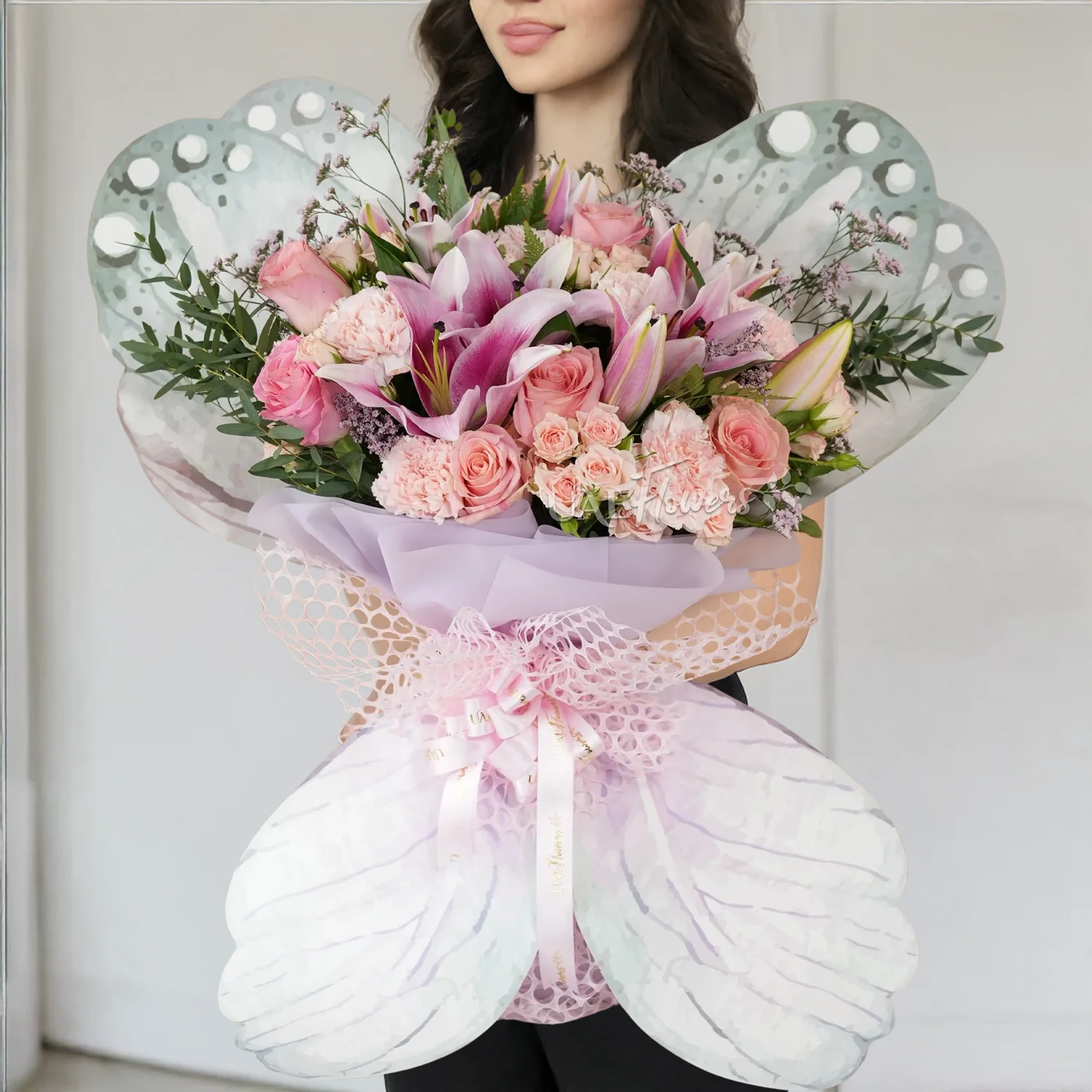 butterfly-shaped bouquet with 2 pink lilies, 5 pink roses, 5 pink carnations