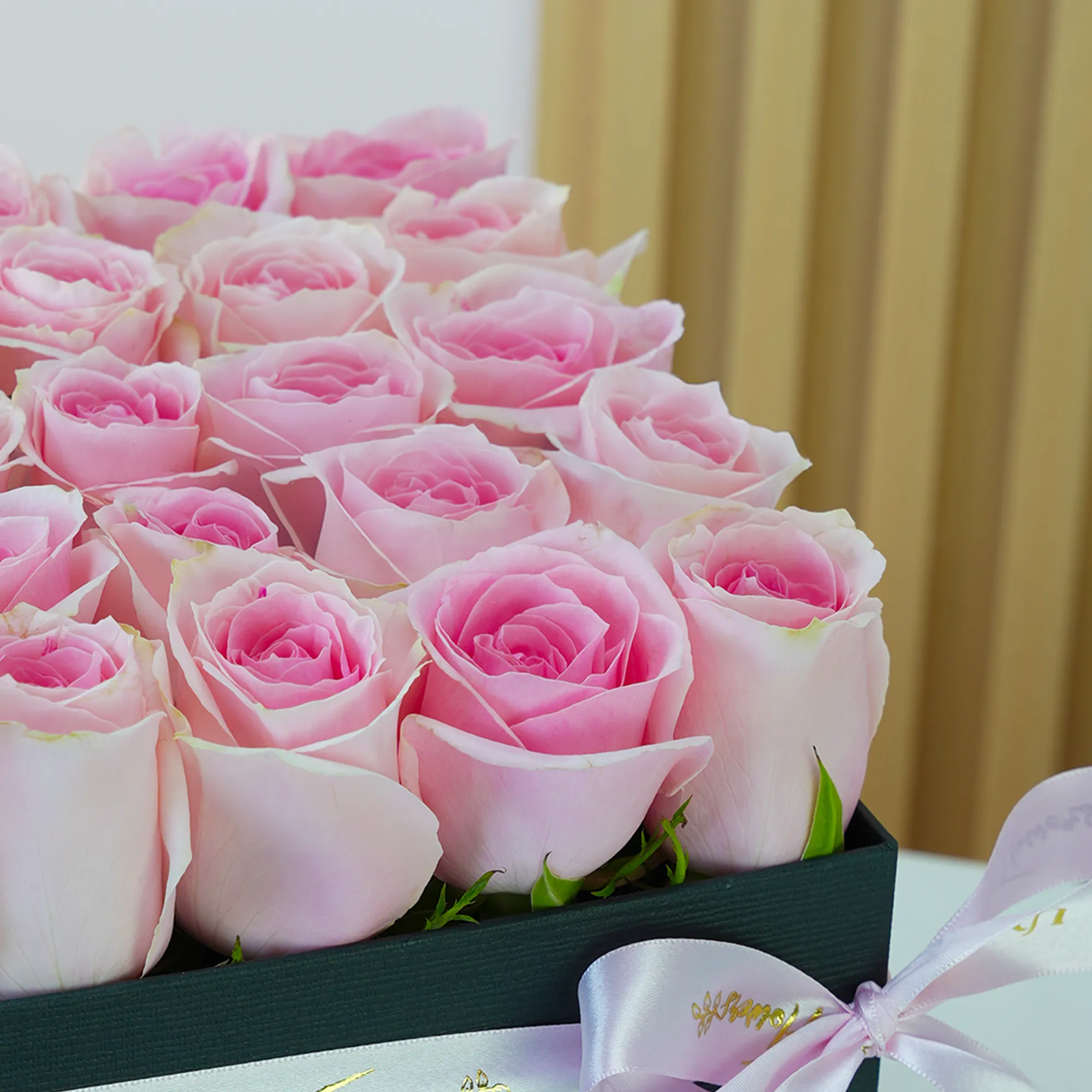 25 pink roses arranged in a square box