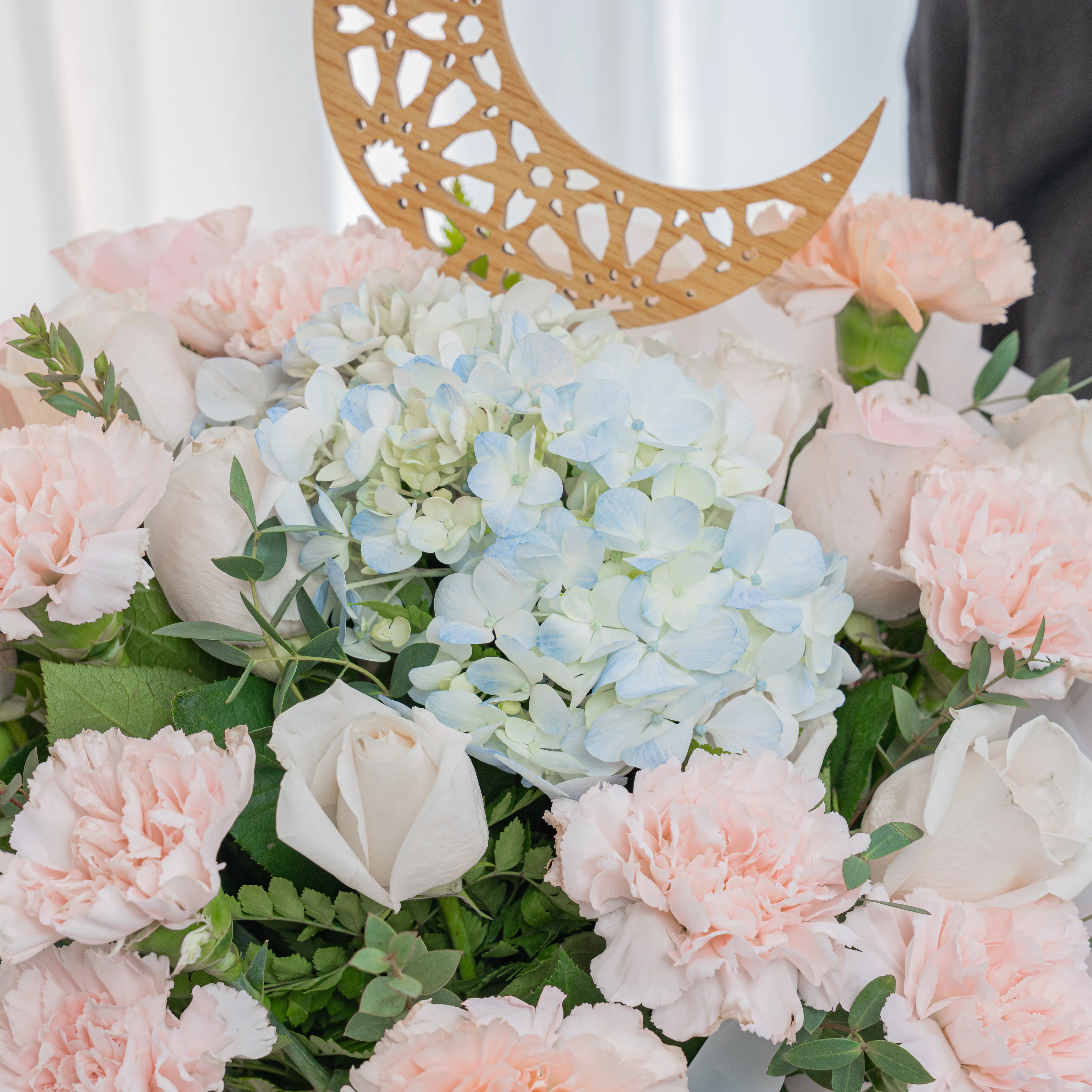 pink carnations, white roses and blue hydrangea bouquet