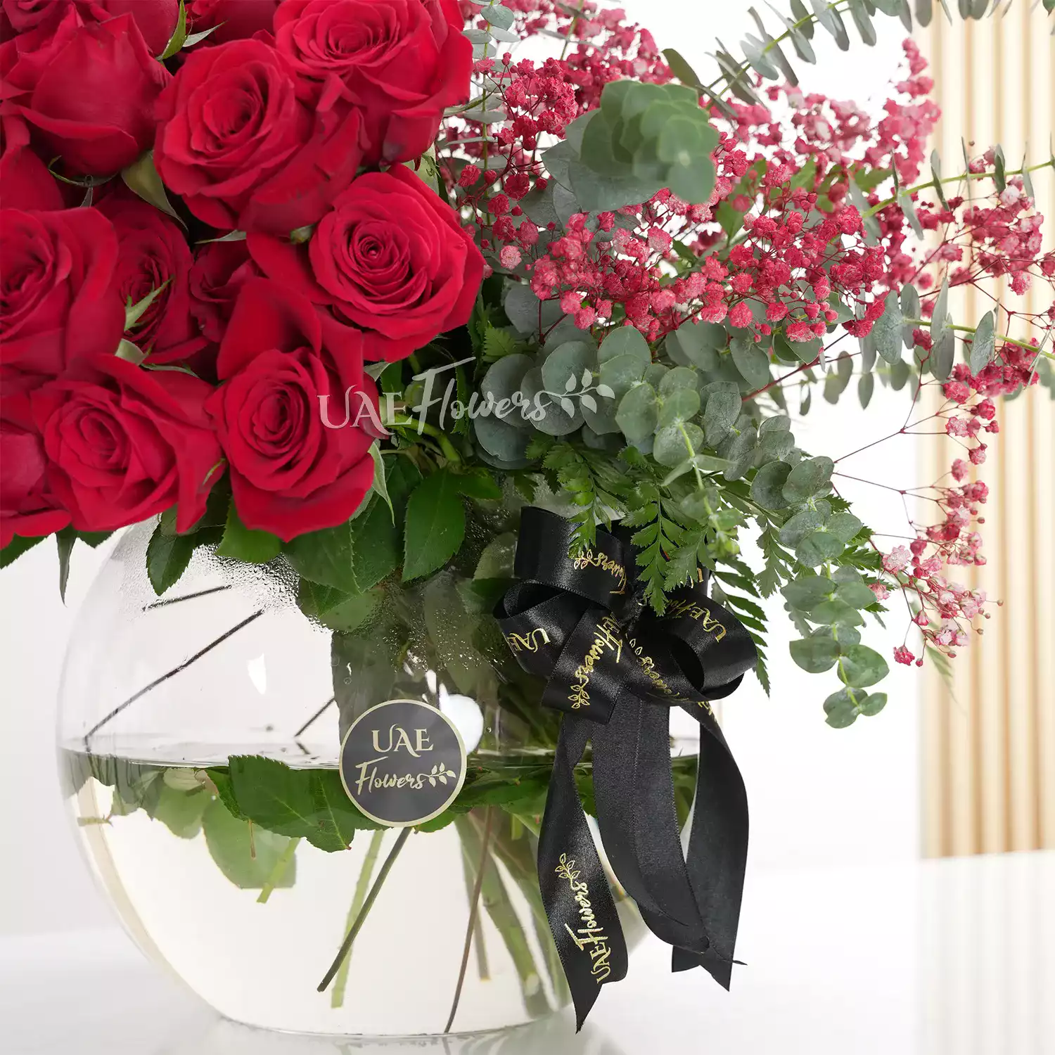 red roses, eucalyptus, and red baby's breath