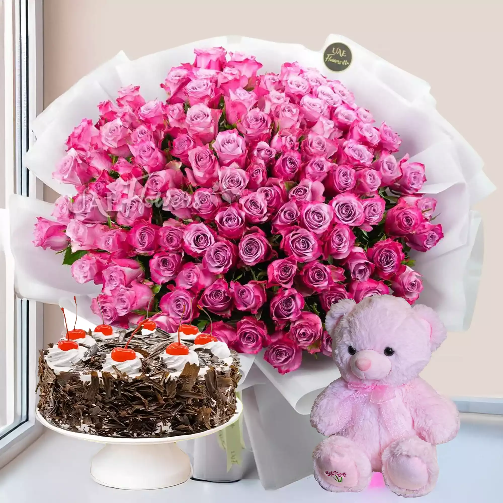 100 purple roses with fillers in white wrap, 1 kg black forest cake