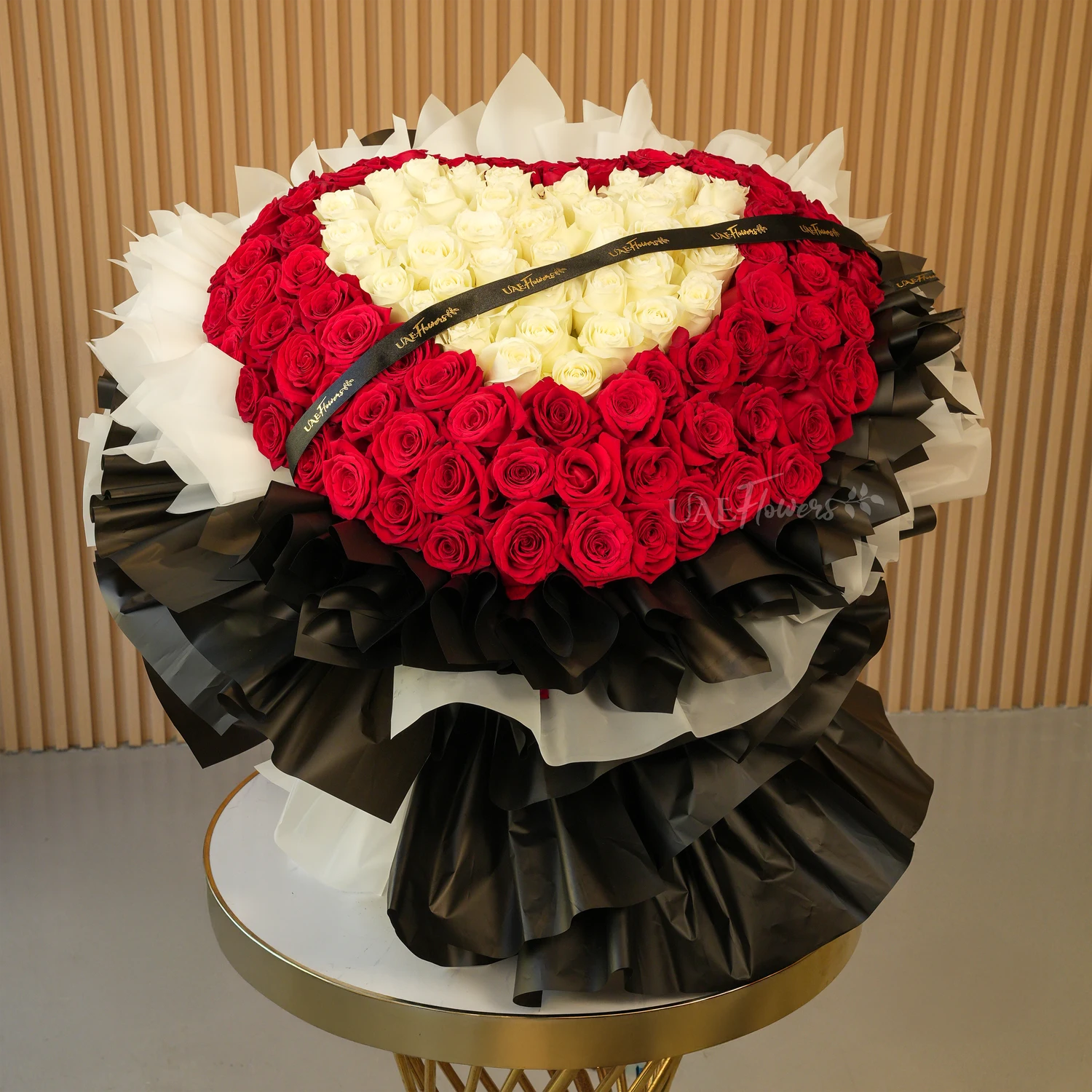 heart-shaped bouquet with 100 red and 50 white roses