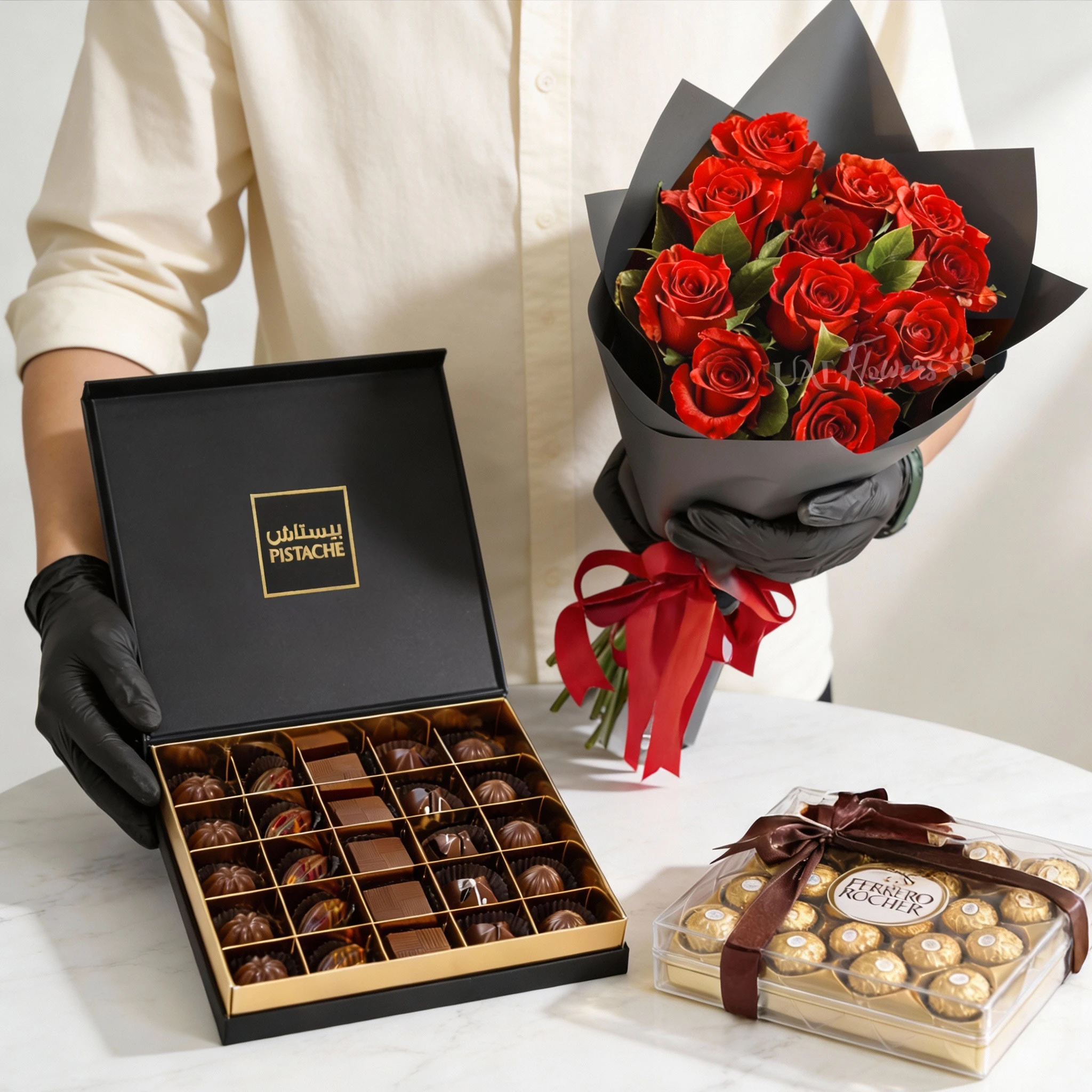 Bouquet of 10 red roses in black wrapping with Ferrero Rocher and Pistache chocolates, a luxury romantic flower and chocolate gift set.