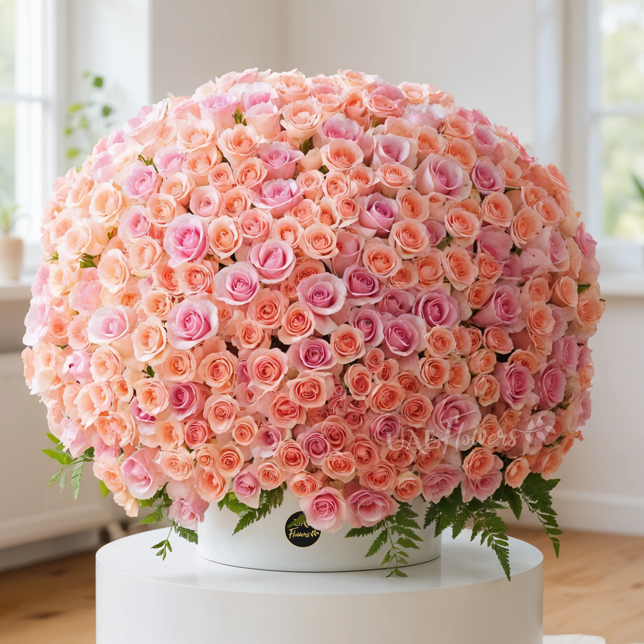 A round Arrangement of 300 pink roses with fillers in the box