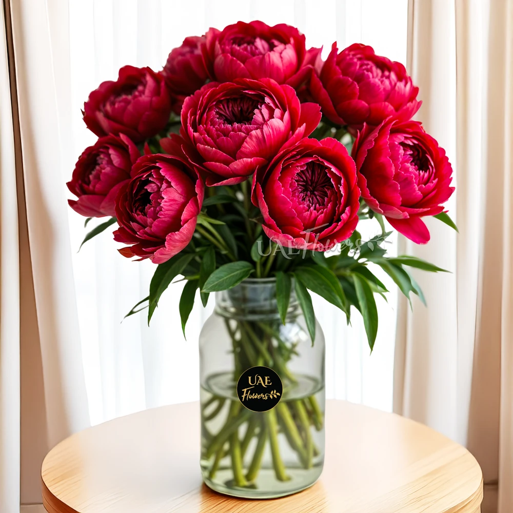 10 stems of Red Peonies in a glass vase