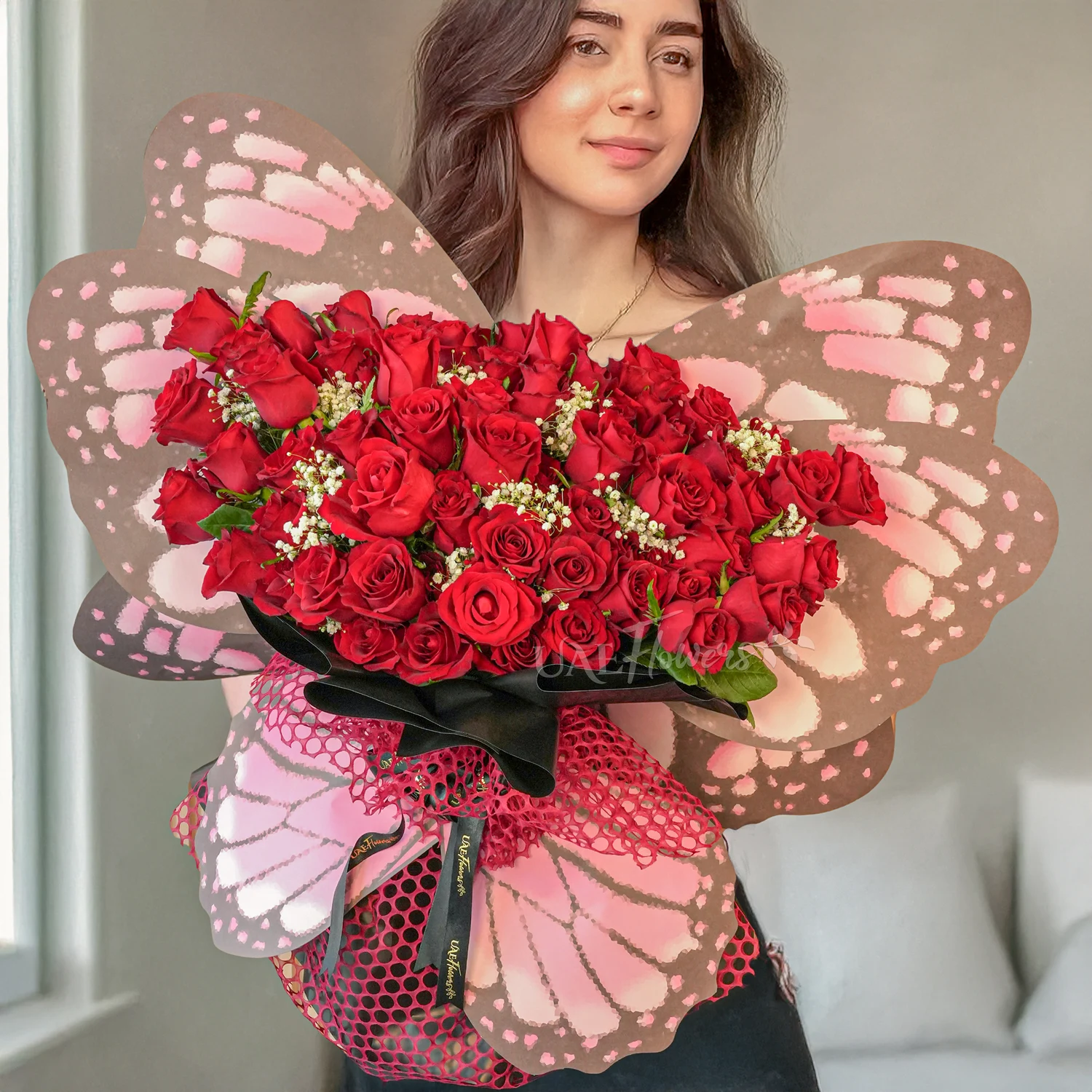 butterfly bouquet of 50 red roses with baby’s breath and green fillers