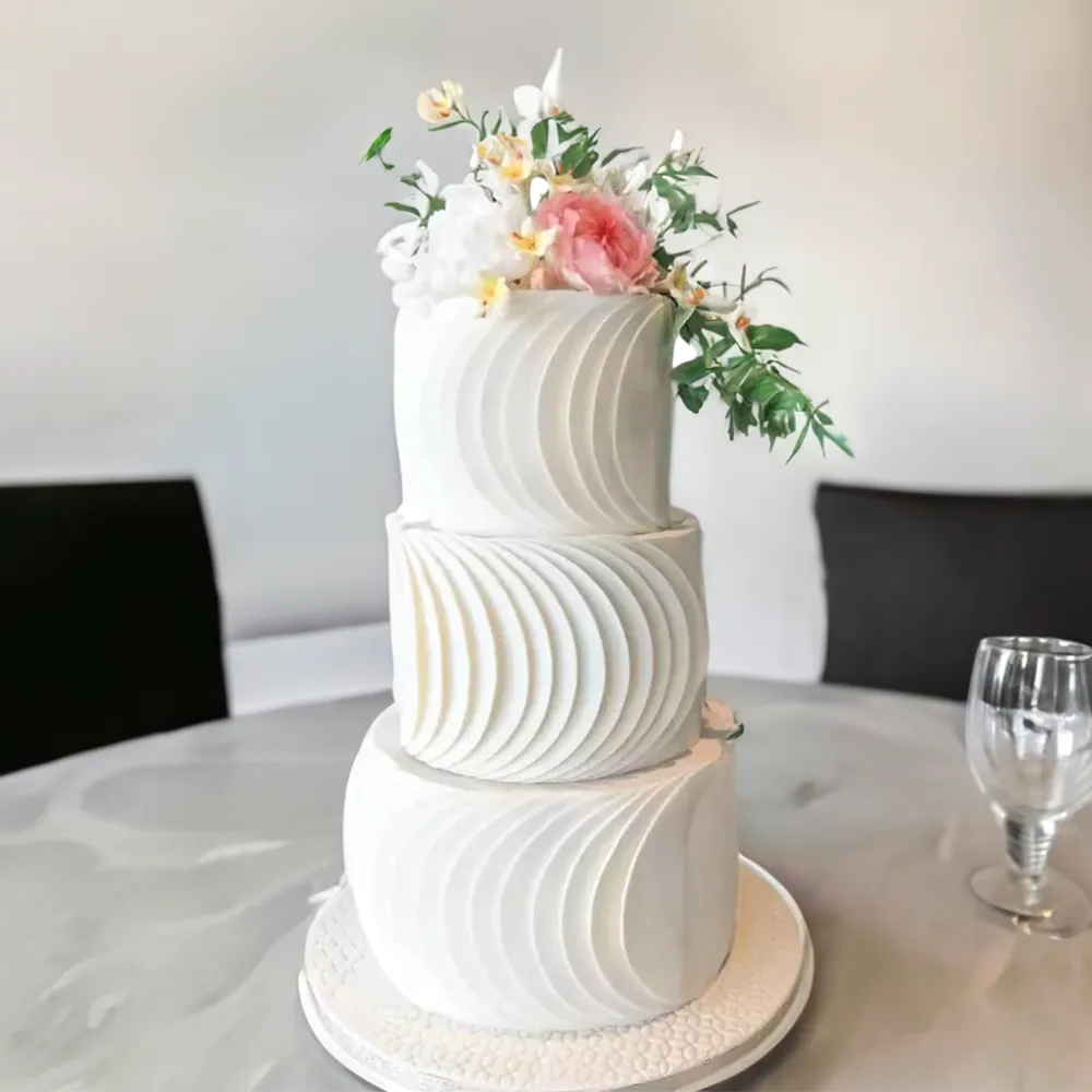 12 kg round layered wedding cake with chocolate sponge and chocolate ganache.