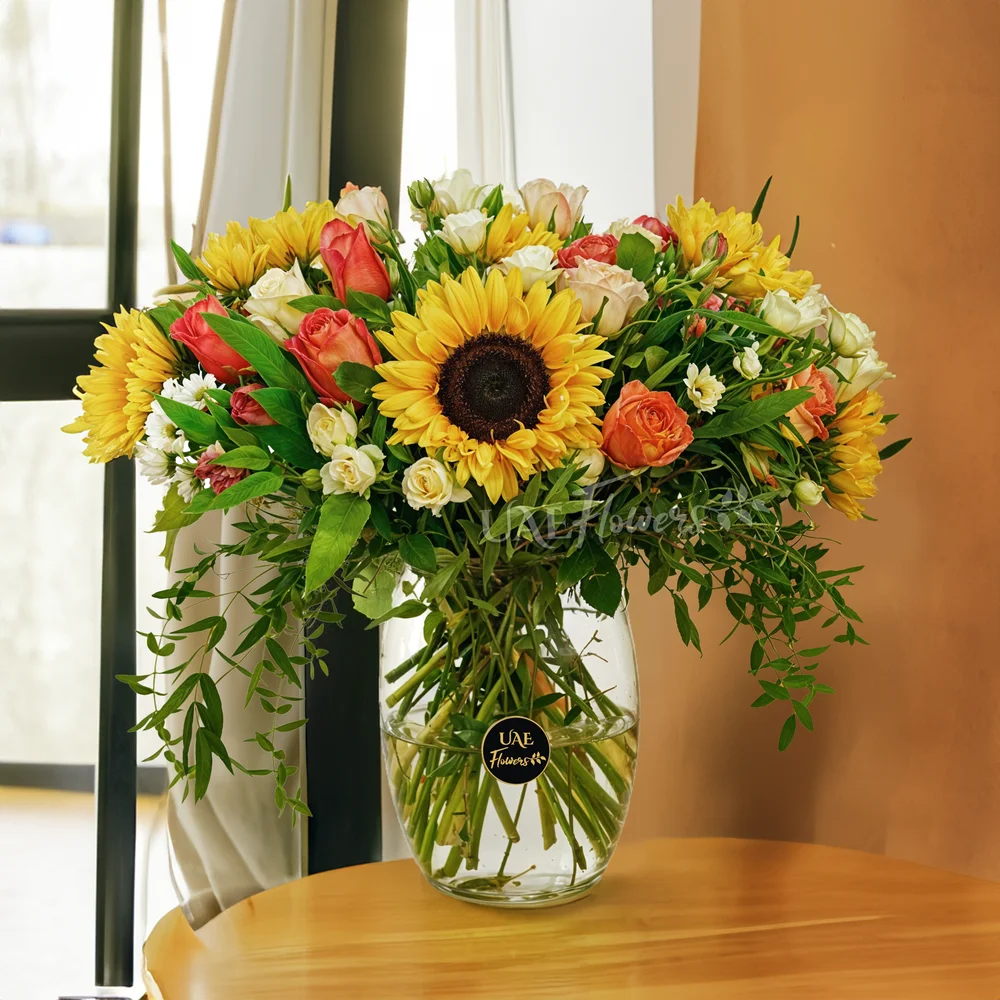 5 sunflowers, 7 orange roses, 7 peach roses, 3 white spray roses, 3 red alstroemerias