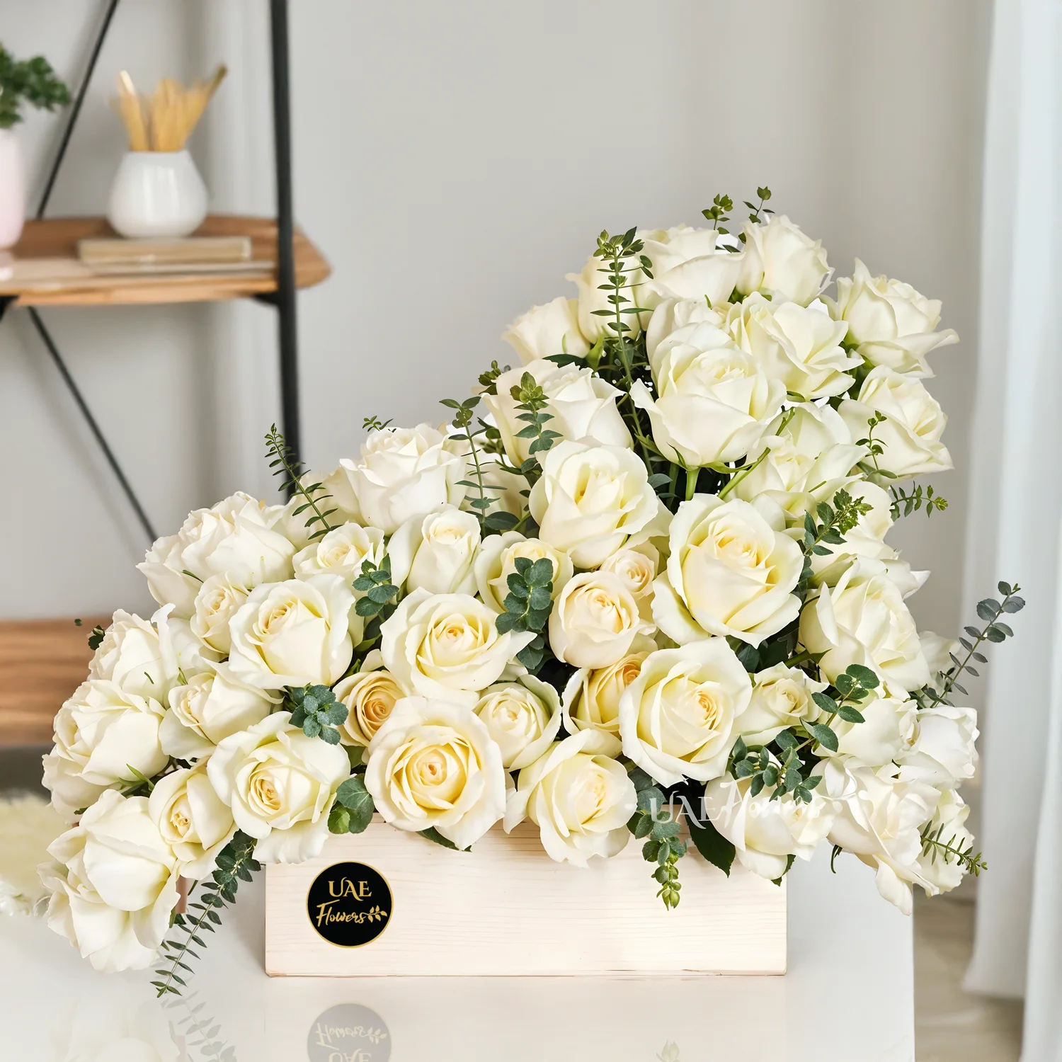 Wooden box with 40 white roses, fresh eucalyptus leaves, and green fillers for an elegant floral display.